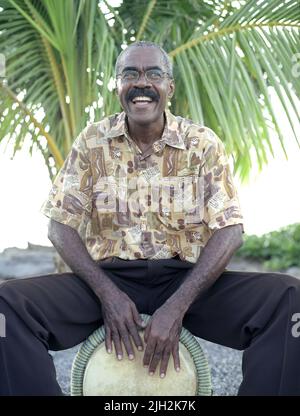 A Bele drummer plays by the beach. Fort de France, Martinique. French Caribbean. Stock Photo