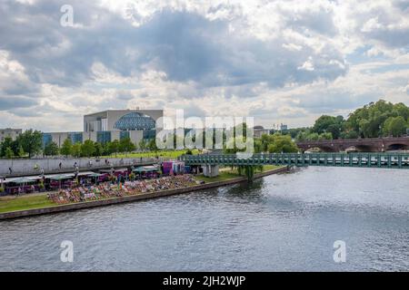 Berlin, Germany - July 29, 2021: View to a promenade of the river Spree in the government district of Berlin, Germany. Stock Photo