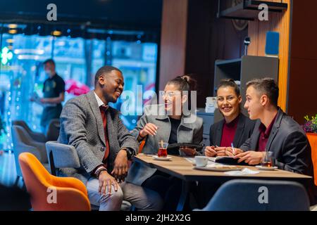 Group of multiracial busniess people are having a conversation about the business while laughing Stock Photo