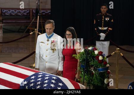Washington DC, USA. 14th July, 2022. Britt Slabinski (L), a retired US Navy Seal and Medal of Honor recipient, and a woman hold hands as they pay their respects to Marine Chief Warrant Officer 4 Hershel Woodrow 'Woody' Williams, the last surviving World War II Medal of Honor recipient, whose casket lies in honor in the Rotunda of the U.S. Capitol, in Washington, DC on Thursday, July 14, 2022. The Marine Corps veteran, who died June 29th, was awarded the nation's highest award for his actions on Iwo Jima. Pool Photo by Eric Lee/UPI Credit: UPI/Alamy Live News Stock Photo