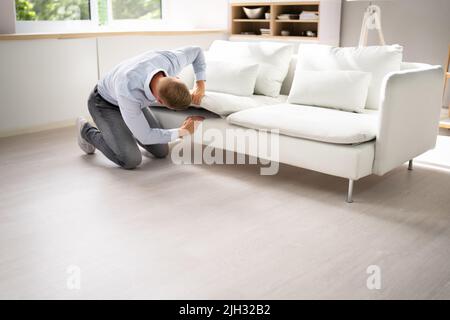 Man Looking For Lost Keys Or Searching Something Stock Photo