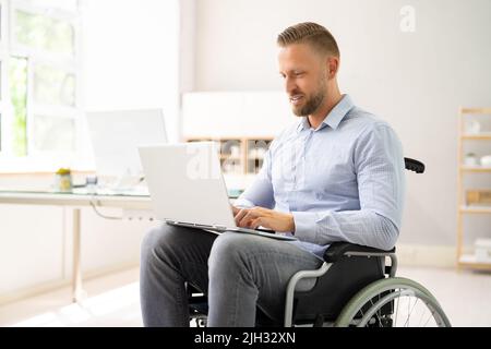 Young Worker With Disability In Wheel Chair Stock Photo