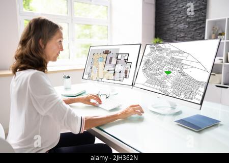 Developer Looking At Land Plot Map And Cadastre Plan Stock Photo