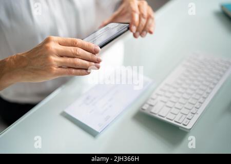 Remote Cheque Deposit Using Mobile Phone. Check Capture Stock Photo