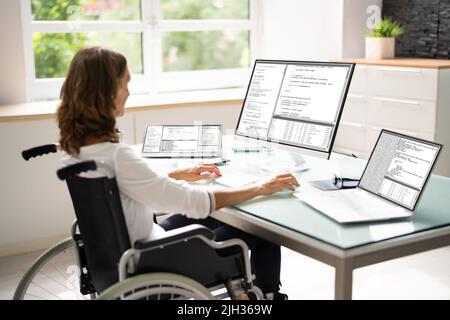 Programmer Woman Coding On Multiple Computer Screens Stock Photo