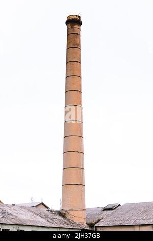 Photograph of the high chimney stack at the now closed historic Portland Cement Works in Portland in The Central Tablelands in Australia Stock Photo