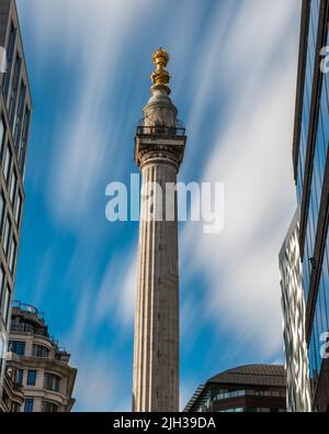 The Monument to the Great Fire of London (moving clouds), London, UK Stock Photo