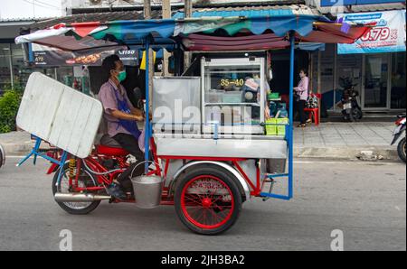 SAMUT PRAKAN, THAILAND, MAY 12 2022, A vendor ride on a motorized tricycle on a street. Stock Photo