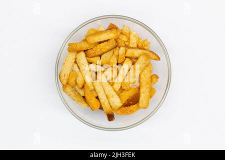 Bread rusks in a transparent glass bowl on a white background. Isolated. Dessert and snack. Wheat rye crackers. Fried croutons to beer. Sliced toast. Stock Photo