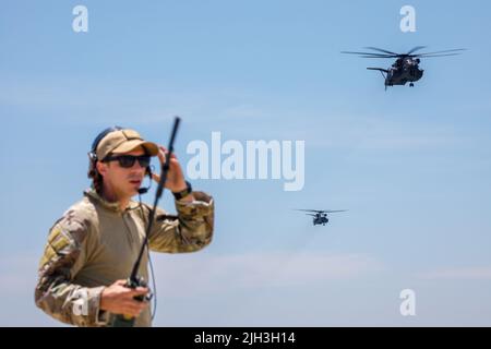 220713-N-N0842-1222 SAN DIEGO (July 13, 2022) Royal Australian Navy Lt. Cmdr. David Miln, exercise coordinator for Rim of the Pacific (RIMPAC) 2022 Southern California (SOCAL), directs MH-53E Sea Dragon helicopters attached to the 'Vanguards' of Helicopter Mine Countermeasures Squadron (HM) 15, and 'Blackjacks' of HM 14 during a practice run for a RIMPAC SOCAL photo exercise. Twenty-six nations, 38 ships, four submarines, more than 170 aircraft and 25,000 personnel are participating in RIMPAC from June 29 to Aug. 4 in and around the Hawaiian Islands and Southern California. The world’s largest Stock Photo