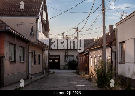 Picture of a street in the city of Sremska Mitrovica, empty, with nobody, in a typical rural landscape in Vojvodina, Serbia, at dusk Stock Photo