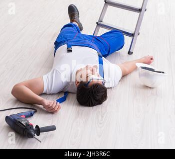 The worker after falling from height - unsafe behavior Stock Photo
