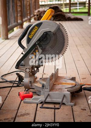 Santa Elena, Medellín, Antioquia, Colombia - May 17 2022: Electric Miter Saw full of Dust on Wooden Floor Stock Photo
