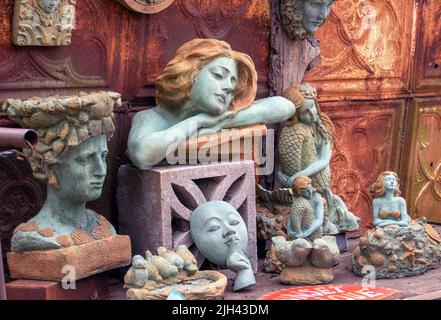 A variety of cement cast statues are offered for sale at an outdoor market in Michigan USA Stock Photo