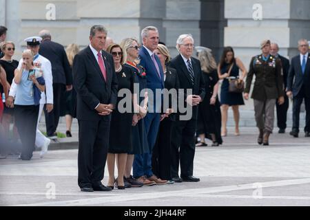 Washington DC, USA. 14th July, 2022. United States Senator Joe Manchin III (Democrat of West Virginia), Speaker of the US House of Representatives Nancy Pelosi (Democrat of California), US Representative Carol Miller (Republican of West Virginia), US House Minority Leader Kevin McCarthy (Republican of California), US Senator Shelley Moore Capito (Republican of West Virginia), and US Senate Minority Leader Mitch McConnell (Republican of Kentucky) watch the casket of Marine Chief Warrant Officer 4 Hershel Woodrow Woody Williams, the last surviving World War II Medal of Honor recipient, being c Stock Photo