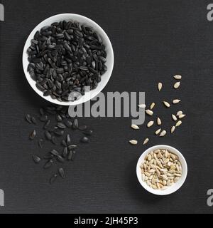 Black sunflower fried seeds peeled and unpeeled Stock Photo - Alamy