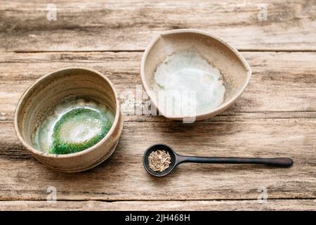 Old pottery on beige wooden background close-up Stock Photo