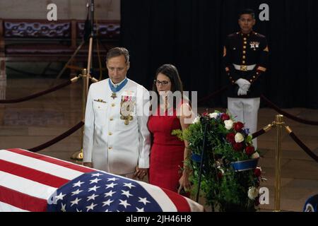 Washington DC, USA. 14th July, 2022. Britt Slabinski (L), a retired US Navy Seal and Medal of Honor recipient, and a woman hold hands as they pay their respects to Marine Chief Warrant Officer 4 Hershel Woodrow “Woody” Williams, the last surviving World War II Medal of Honor recipient, whose casket lies in honor in the Rotunda of the US Capitol, in Washington, DC, USA, July 14, 2022. The Marine Corps veteran, who died June 29th, was awarded the nation’s highest award for his actions on Iwo Jima. Photo by Eric Lee/Pool/ABACAPRESS.COM Credit: Abaca Press/Alamy Live News Stock Photo