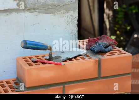 Close up on house bricklaying tools on house construction site. Stock Photo