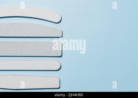Set of polishing files for nails. Tools for manicure on a blue background with copy space. Stock Photo