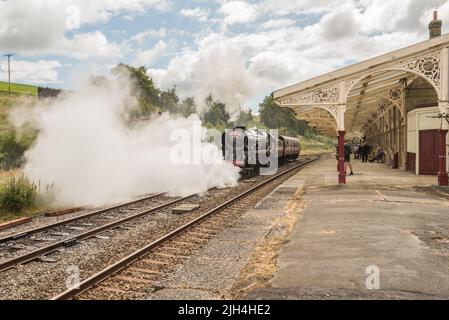 British India Line  vents steam as it is about to set off for linking up to the  diesel hauled part of York to Carlisle Dalesman tour, 14th July 2022 Stock Photo