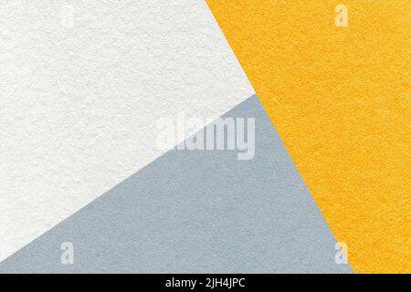 Texture of craft white, yellow and gray shade color paper background, macro. Structure of vintage abstract cardboard with geometric shape and gradient Stock Photo
