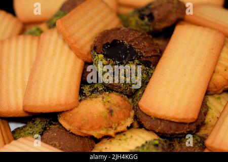 Traditional Arabic cookies for celebration of Islamic holidays of El-Fitr feast, Egyptian Eid biscuits and petit four (mignardises) stuffed with jam a Stock Photo