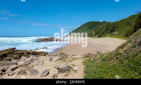 St Lucia South Africa, Rocks sand ocean, and blue coastal skyline at Mission Rocks beach near Cape Vidal in Isimangaliso Wetland Park in Zululand. South Africa St Lucia Stock Photo