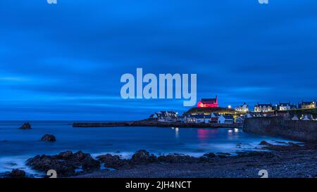 The red church in Findochty located on a very prominent, commanding site, on high land overlooking the small fishing village on the Moray coast Stock Photo