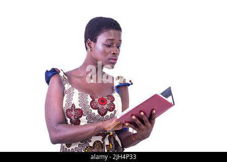 beautiful young businesswoman in dress standing on white background looking at diary Stock Photo