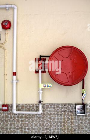 Wall mounted fire alarm and water hose system Stock Photo