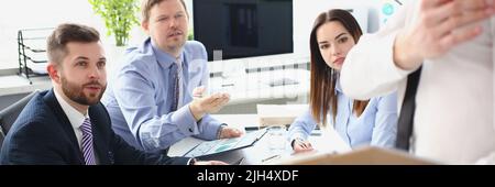 Smart man making presentation for colleagues, manager showing finance statistics to team Stock Photo