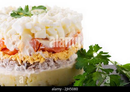 Traditional Russian layered salad Mimosa isolated on white background Stock Photo