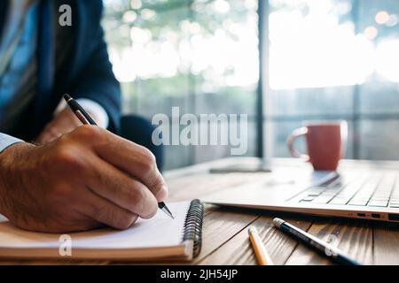 Male hand taking notes on the notepad Stock Photo