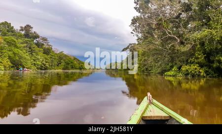 Puerto Narino, Columbia - Feb. 14, 2017: Boating on the Lago Tarapoto. Traveling with a canoe boat on Amazon River in Latin America. Tropical forest Stock Photo