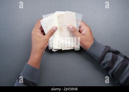 holding old craft paper on black background top view  Stock Photo