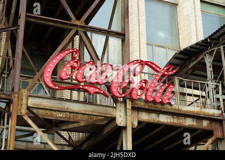 New York, USA - July 15, 2022: Old vintage sign of Coca-Cola drink on the facade of the building. Retro, design, style concept. High quality photo Stock Photo