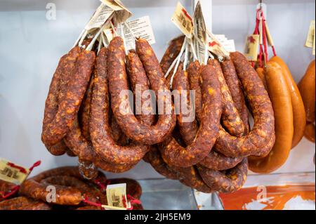 Sausages or charcuterie hanging up for sale in a shop in Spain Stock Photo