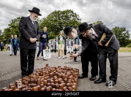 Westerbork, Netherlands. 15th July, 2022. 2022-07-15 16:12:24 WESTERBORK - Chief Rabbi Binyomin Jacobs (L) and Rabbi Ies Vorst (M) place photos at the monument The 102,000 stones during the commemoration of the first transport at Camp Westerbork. It has been eighty years since the first train departed from Camp Westerbork with 1137 Jews to Auschwitz. ANP SEM VAN DER WAL netherlands out - belgium out Credit: ANP/Alamy Live News Stock Photo