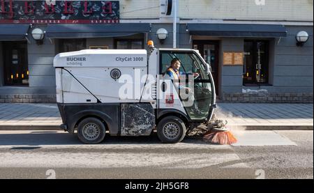 January 21, 2022, Moscow, Russia. A Bucher Schorling vacuum sweeper on a street in the Russian capital on a sunny winter day. Stock Photo