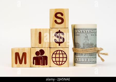 Business concept. On a white surface, dollars and cubes with images and the inscription - MIS Stock Photo