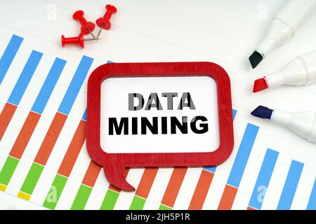 Business and economy concept. There are markers, charts and a sign on the table - DATA MINING Stock Photo
