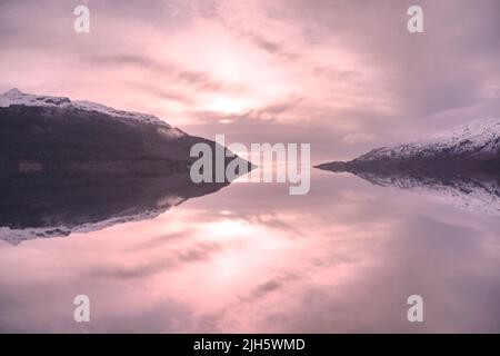 Peaceful calm water during sunset at Loch Lomond Stock Photo