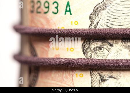 Portrait of Alexander Hamilton in Roll of Ten Dollar Bills. Stock Photo