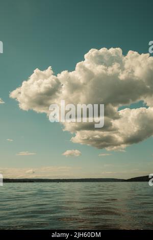 Fluffy white cumulus couds over water, no people Stock Photo