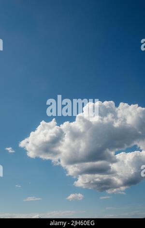 fluffy cumulus clouds against blue sky Stock Photo