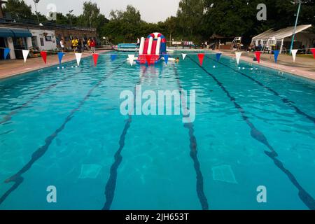 Hampton Open Air swimming pool on a warm and sunny evening with sunset ...