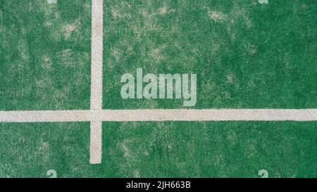 Top view of line on floor and part of green synthetic grass paddle tennis court indoor without people. Padel is a racquet game. Professional sport con Stock Photo