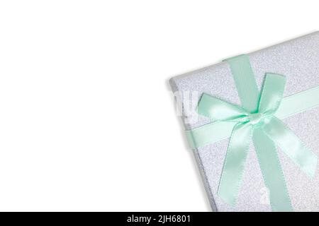 Gift box white background is tied with turquoise ribbon with bow Stock Photo