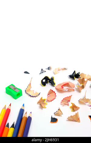 Sharpener and set colored pencils with wooden shavings white background Stock Photo